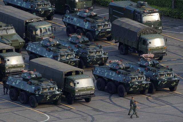 Military vehicles are parked on the grounds of the Shenzhen Bay Sports Center in Shenzhen, China August 15, 2019.  REUTERS/Thomas Peter