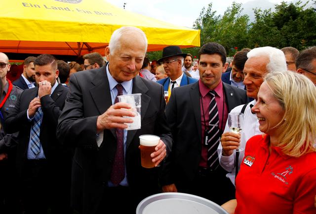 Prince Hans-Adam II of Liechtenstein takes a beer from a waitress during a party celebrating the country's 300th birthday in the gardens of Schloss Vaduz castle in Vaduz, Liechtenstein August 15, 2019. REUTERS/Arnd Wiegmann