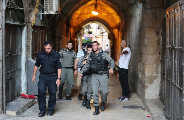 Israeli security personnel walk near the scene where Palestinians were shot by Israeli police after carrying out what Israeli police spokesman said was a stabbing attack in Jerusalem's old city August 15, 2019. REUTERS/Ammar Awad