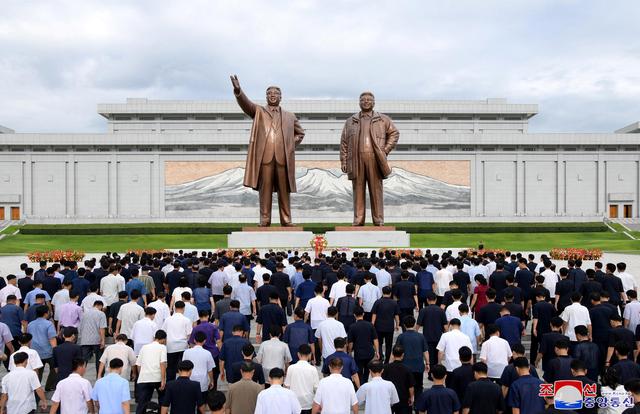 People visit the statues of former North Korean leaders Kim Il Sung and Kim Jong Il to commemorate the 74th anniversary of the end of the Japanese occupation of Korea, in this undated photo supplied by the Korean Central News Agency (KCNA) on August 16, 2019. KCNA/ via REUTERS 