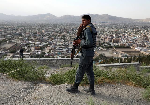 FILE PHOTO: An Afghan policeman keeps watch at a hilltop in Kabul, Afghanistan July 23, 2019.REUTERS/Omar Sobhani/File Photo