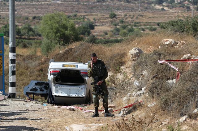 An Israeli soldier stands near the scene of what Israeli military said is a car-ramming attack near the settlement of Elazar in the Israeli-occupied West Bank August 16, 2019. REUTERS/Ammar Awad