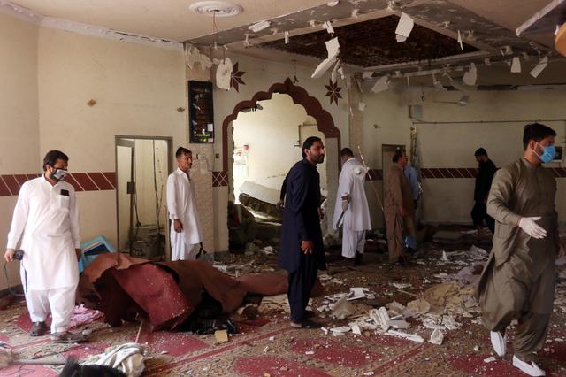 Members of a bomb disposal unit survey the site after a blast at a mosque in Kuchlak, in the outskirts of Quetta, Pakistan August 16, 2019. REUTERS/Stringer 