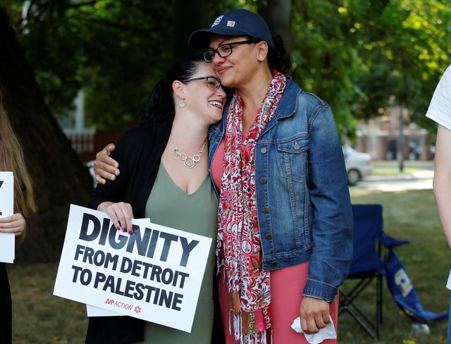U.S. Congresswoman Rashida Tlaib (R) stands with supporter Bridget Huff during a ‘Shabbat in the Park’ in Detroit, Michigan, U.S. August 16, 2019.  REUTERS/Rebecca Cook