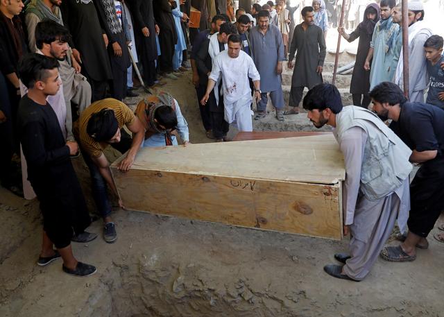 Men carry a coffin as they take part in a burial ceremony of the victims of a suicide bomb blast at a wedding in Kabul, Afghanistan August 18, 2019. REUTERS/Mohammad Ismail