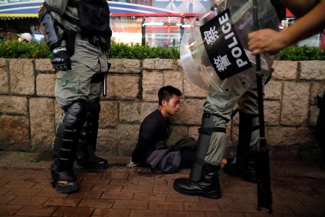 Riot police officers detain an anti-extradition bill protester during a demonstration in Tsim Sha Tsui neighbourhood in Hong Kong, China, August 11, 2019. REUTERS/Issei Kato