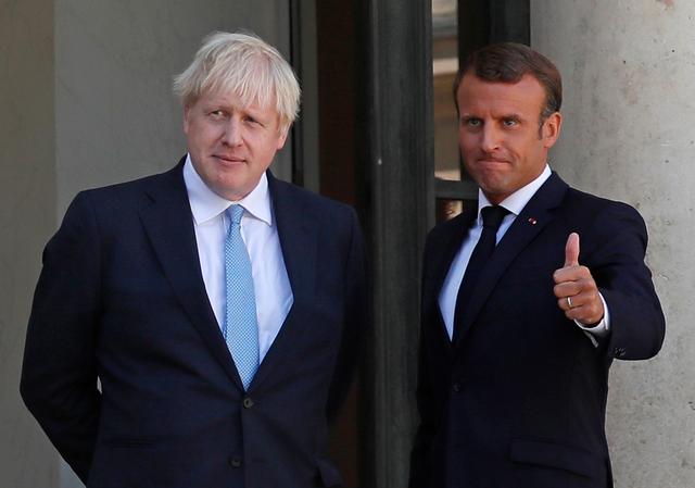 French President Emmanuel Macron reacts next to British Prime Minister Boris Johnson after a joint statement before a meeting on Brexit at the Elysee Palace in Paris, France, August 22, 2019. REUTERS/Gonzalo Fuentes