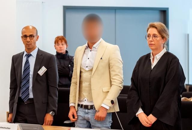 Alaa S., suspected of being responsible for the stabbing of Daniel H. in Chemnitz, his interpreter and lawyer Ricarda Lang arrive at a court in Dresden, Germany, August 22, 2019. Picture pixelated at source.      Matthias Rietschel/Pool via REUTERS