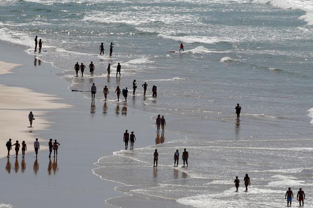 People walk on the Cote des Basques beach on the eve of the G7 summit in Biarritz, France, August 23, 2019.  REUTERS/Regis Duvignau