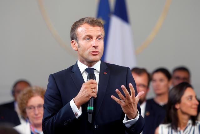 FILE PHOTO: French President Emmanuel Macron delivers a speech on environment and social equality to business leaders on the eve of the G7 summit in Paris, France August 23, 2019. Michel Spingler/Pool via REUTERS