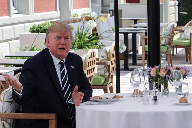 U.S. President Donald Trump sits to lunch with French President Emmanuel Macron (not pictured) on the first day of the annual G7 Summit, at Hotel du Palais in Biarritz, France August 24, 2019. Ludovic Marin/Pool via REUTERS