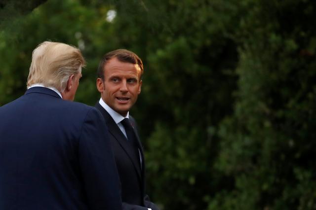 French President Emmanuel Macron welcomes U.S. President Donald Trump at the G7 summit in Biarritz, France, August 24, 2019. REUTERS/Christian Hartmann