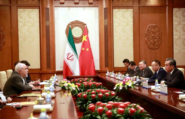 Iranian Foreign Minister Mohammad Javad Zarif (L) speaks with Chinese Foreign Minister Wang Yi (R)  during their meeting at the Diaoyutai State Guesthouse in Beijing, China August 26, 2019.  How Hwee Young/Pool via REUTERS