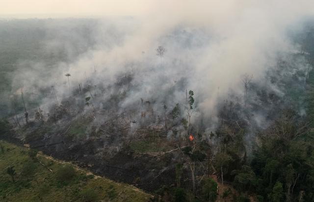 FILE PHOTO: An aerial view of a tract of the Amazon jungle burning as it is being cleared by loggers and farmers in Porto Velho, Rondonia State, Brazil, is pictured in this August 23, 2019 picture taken with a drone. Picture taken August 23, 2019 REUTERS/Ueslei Marcelino