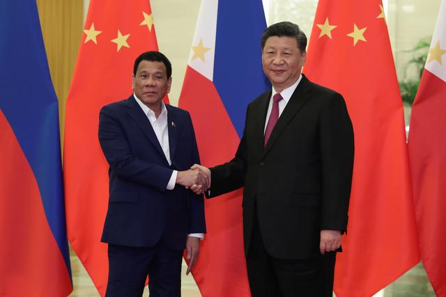 FILE PHOTO: Philippine President Rodrigo Duterte shakes hands with Chinese President Xi Jinping before the meeting at the Great Hall of People in Beijing, China on April 25, 2019.  Kenzaburo Fukuhara/Pool via REUTERS