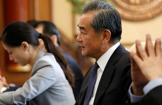 Chinese Foreign Minister Wang Yi (R) listens to Minister for the Office of the State Counsellor of Myanmar Kyaw Tint Swe (not pictured) at the Diaoyutai State Guesthouse in Beijing, China August 27, 2019. How Hwee Young/Pool via REUTERS