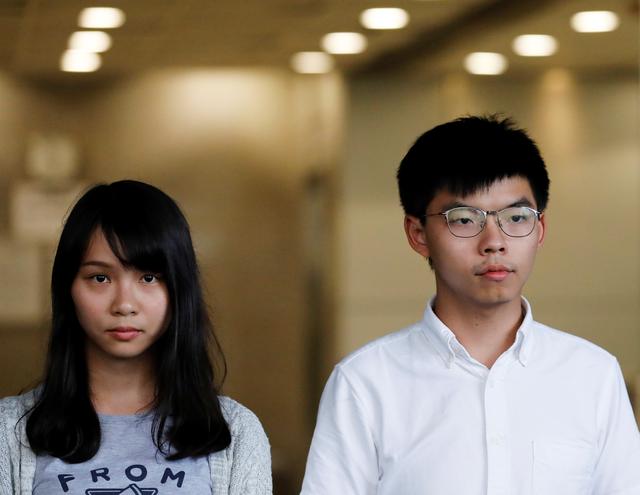 Pro-democracy activists Joshua Wong and Agnes Chow leave the Eastern Court after being released on bail in Hong Kong, China August 30, 2019. REUTERS/Anushree Fadnavis