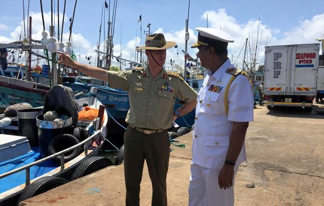 Head of Australia's operation to combat illegal maritime migration Major General Craig Furini inspects the western fisheries harbor next to Sri Lanka Navy Director-General operations Niraja Attygalle after a news conference about illegal migrations during his visit, in Negombo, Sri Lanka, September 3, 2019. REUTERS/Ranga Sirilal