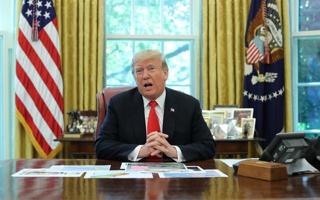 U.S. President Donald Trump talks to reporters as he receives a status report on Hurricane Dorian in the Oval Office of the White House in Washington, U.S., September 4, 2019. REUTERS/Jonathan Ernst