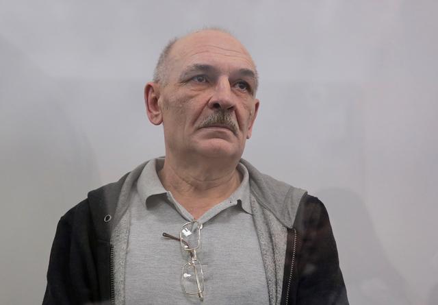 Volodymyr Tsemakh, suspected of involvement in the downing of the Malaysia Airlines flight MH17 plane in 2014, stands inside a defendants' cage during a court hearing in Kiev, Ukraine September 5, 2019. REUTERS/Serhii Nuzhnenko