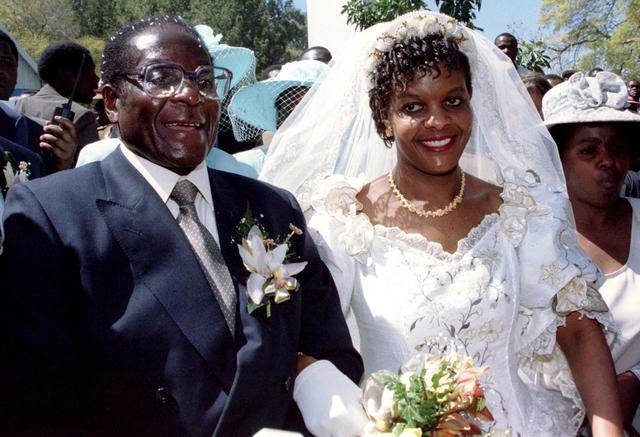 FILE PHOTO: President Robert Mugabe and new wife Grace leave the Kutama Catholic Church in Zimbabwe August 17, 1996 after exchanging their wedding vows. REUTERS/Howard Burditt/File Photo