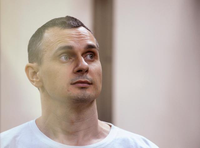 FILE PHOTO: Ukrainian film director Oleg Sentsov looks on from a defendants' cage as he attends a court hearing in Rostov-on-Don, Russia, August 25, 2015. REUTERS/Sergey Pivovarov/File Photo