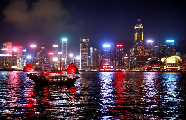 FILE PHOTO: A junk boat passes the skyline as seen from the Tsim Sha Tsui waterfront in Hong Kong, China, August 27, 2019. REUTERS/Kai Pfaffenbach