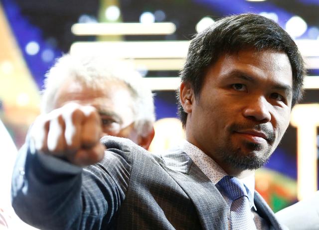 FILE PHOTO: Philippine boxing icon Manny Pacman Pacquiao poses for photographers during a news conference with welterweight world title holder Lucas Matthysse (not pictured), for their upcoming WBA regular welterweight title fight, at a hotel in Kuala Lumpur, Malaysia April 20, 2018. REUTERS/Lai Seng Sin