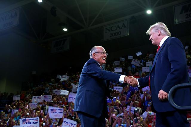 FILE PHOTO - Former New York mayor Rudy Giuliani greets Republican U.S. presidential nominee Donald Trump at the Trask Coliseum at University of North Carolina in Wilmington, North Carolina, U.S., August 9, 2016. REUTERS/Eric Thayer
