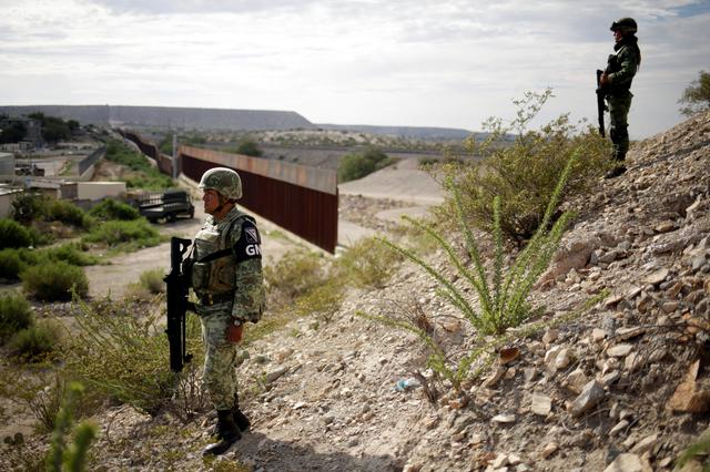 FILE PHOTO - Soldiers assigned to the National Guard keep watch near a section of the border fence between Mexico and U.S. as seen from Anapra neighborhood in Ciudad Juarez, Mexico September 5, 2019.  REUTERS/Jose Luis Gonzalez