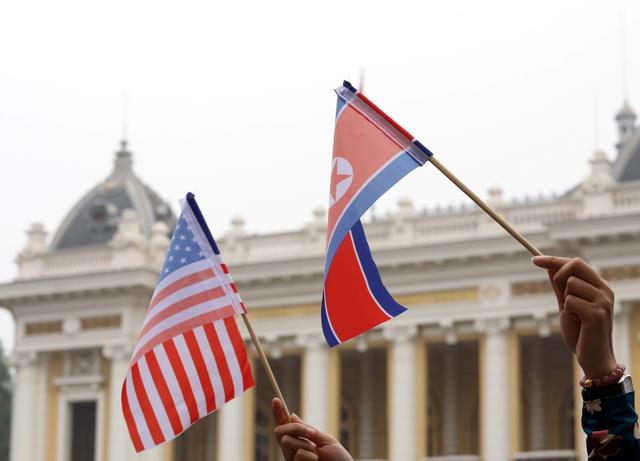 FILE PHOTO - Residents hold US and North Korean flags while they wait for motorcade of North Korea's leader Kim Jong Un en route to the Metropole Hotel for the second US- North Korea summit in Hanoi, Vietnam February 28, 2019. REUTERS/Kham