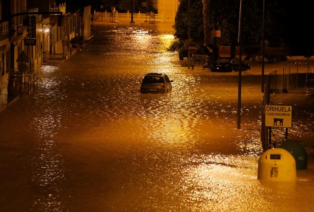 A car is stuck on a flooded street as torrential rains hit Orihuela, near Murcia, southeastern Spain, September 12, 2019. Picture taken September 12, 2019. REUTERS/Jon Nazca