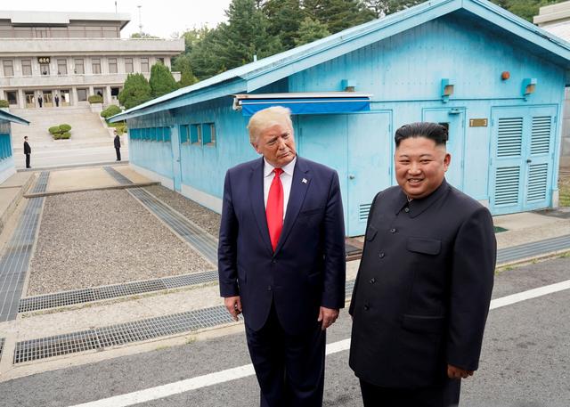 FILE PHOTO: U.S. President Donald Trump meets with North Korean leader Kim Jong Un at the demilitarized zone separating the two Koreas, in Panmunjom, South Korea, June 30, 2019. REUTERS/Kevin Lamarque/File Photo/File Photo