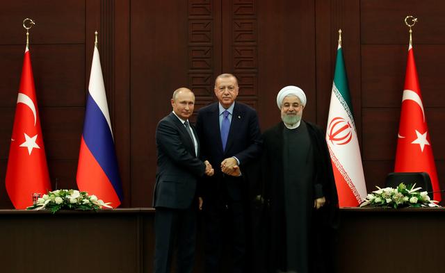 Presidents Vladimir Putin of Russia, Tayyip Erdogan of Turkey and Hassan Rouhani of Iran pose following a joint news conference in Ankara, Turkey, September 16, 2019. REUTERS/Umit Bektas