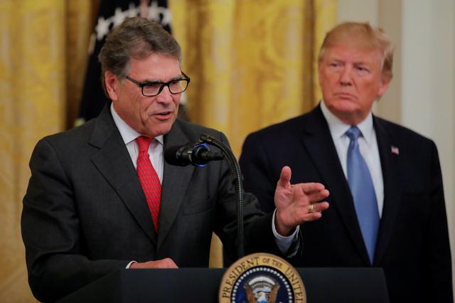 FILE PHOTO: U.S. President Donald Trump listens to U.S. Energy Secretary Rick Perry speak during an event touting the administration's environmental policy in the East Room of the White House in Washington, U.S., July 8, 2019. REUTERS/Carlos Barria/File Photo