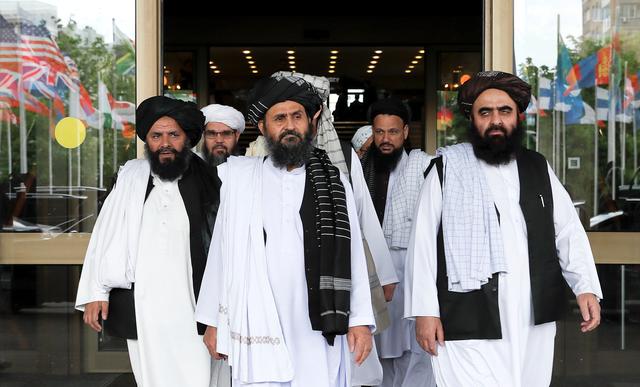 FILE PHOTO: Members of a Taliban delegation, led by chief negotiator Mullah Abdul Ghani Baradar (C, front), leave after peace talks with Afghan senior politicians in Moscow, Russia May 30, 2019. REUTERS/Evgenia Novozhenina/File Photo