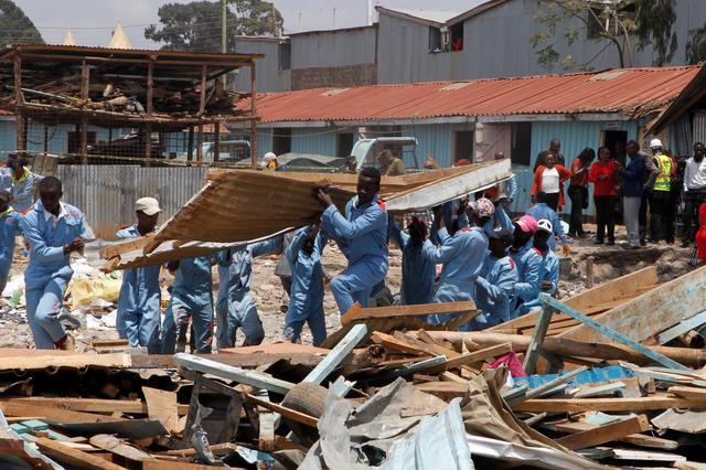 Rescue workers go through the rubble at the site of a collapsed school classroom, in Nairobi, Kenya, September 23, 2019. REUTERS/Njeri Mwangi