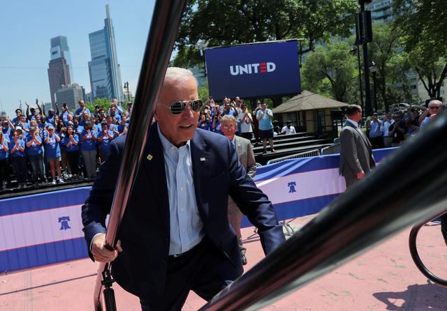 FILE PHOTO: U.S. Democratic presidential candidate and former Vice President Joe Biden runs up the steps onto the stage to begin the kickoff rally of his campaign for the 2020 Democratic presidential nomination in Philadelphia, Pennsylvania, U.S., May 18, 2019. REUTERS/Jonathan Ernst/File Photo