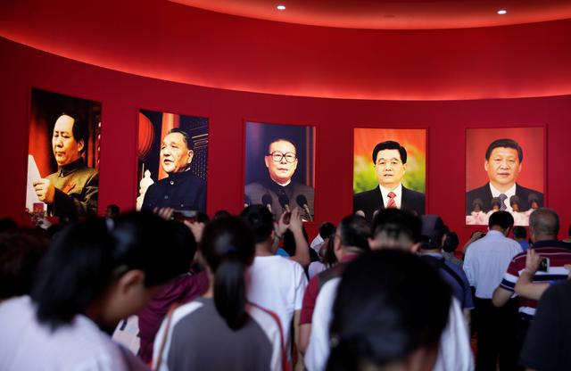 Visitors are seen in front of pictures of late Chinese Chairman Mao Zedong, former Chinese leaders Deng Xiaoping, Jiang Zemin, Hu Jintao and Chinese President Xi Jinping during an exhibition on China's achievements marking the 70th anniversary of the founding of the People's Republic of China (PRC) at the Beijing Exhibition Center, in Beijing, China September 24, 2019. REUTERS/Jason Lee