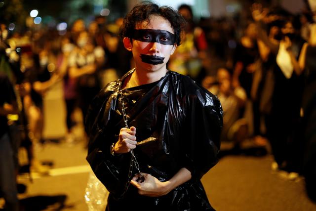 A performer carries a chain outside the venues of first community dialogue holding by Hong Kong Chief Executive Carrie Lam in Hong Kong, China September 26, 2019. REUTERS/Jorge Silva