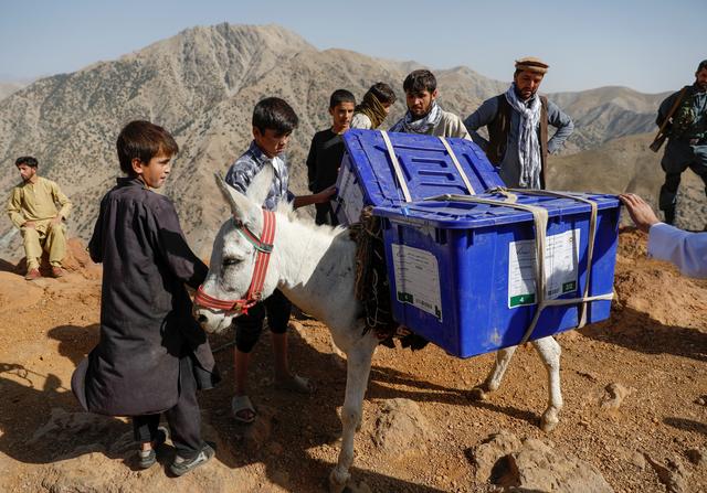 An Afghan man loads ballot boxes and other election material on a donkey to be transported to polling stations which are not accessible by road in Shutul, Panjshir province, Afghanistan September 27, 2019.REUTERS/Mohammad Ismail