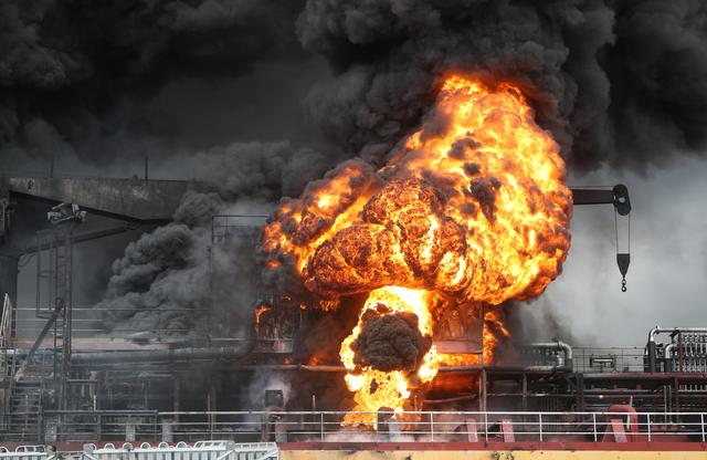 Fire from a vessel is seen at a port in Ulsan, South Korea, September 28, 2019.   Yonhap via REUTERS