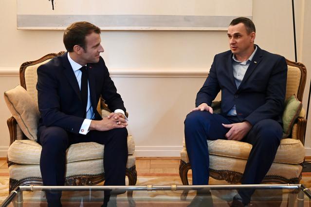 French President Emmanuel Macron speaks with Ukrainian film director Oleg Sentsov at the Permanent Representation of France to the Council of Europe in Strasbourg, France, October 1, 2019. Frederick Florin/Pool via REUTERS