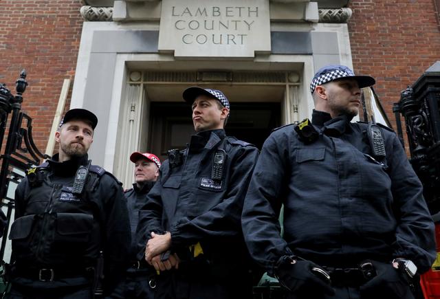 Police officers stand guard outside Lambeth County Court, during a raid on an Extinction Rebellion storage facility, in London, Britain October 5, 2019. REUTERS/Simon Dawson
