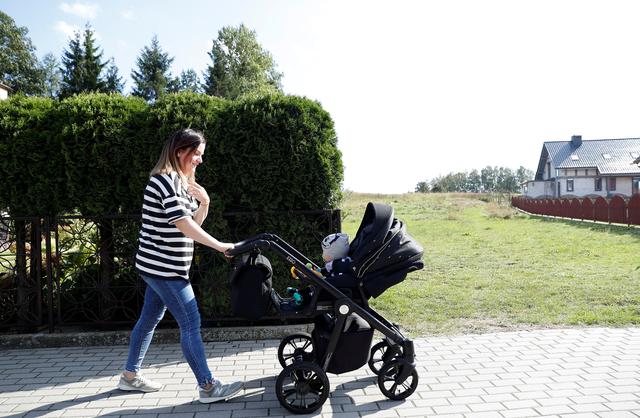 Karolina Burczyk, 26, walks her son Leon on a street in Nowa Karczma, Poland, September 11, 2019. REUTERS/Aleksandra Szmigiel
