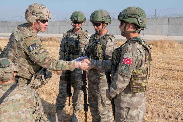 U.S. and Turkish military forces conduct a joint ground patrol inside the security mechanism area in northeast, Syria, October 4, 2019. Picture taken October 4, 2019.  U.S. Army/Staff Sgt. Andrew Goedl/Handout via REUTERS. 