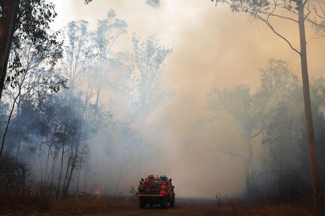 Firefighters battle bushfires in Busbys Flat, northern NSW, Australia, October 9, 2019. AAP Image/Jason O'Brien/via REUTERS  