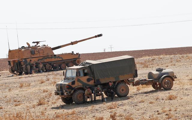 Turkish army vehicles and military personnel are stationed near the Turkish-Syrian border in Sanliurfa province, Turkey, October 12, 2019. REUTERS/Murad Sezer