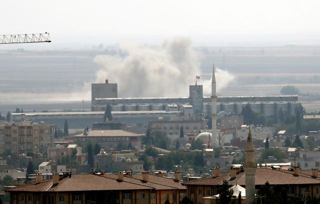 FILE PHOTO: Smoke billows out after Turkish shelling on the Syrian border town of Ras al Ain, as seen from Ceylanpinar, in Sanliurfa province, Turkey, October 13, 2019. REUTERS/Murad Sezer/File Photo