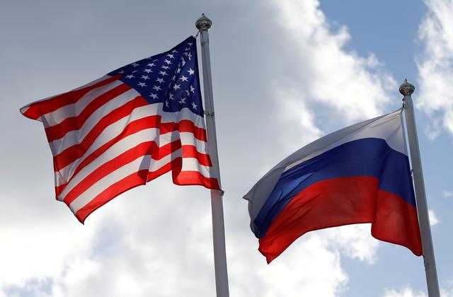 FILE PHOTO: Russian and U.S. state flags fly near a factory of Ford Sollers, a joint venture of U.S. carmaker Ford with Russian partners, in Vsevolozhsk, Leningrad Region, Russia March 27, 2019. REUTERS/Anton Vaganov/File Photo